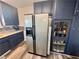 Kitchen with stainless steel fridge, mosaic backsplash, and dark blue cabinets at 3141 Scarlet Oak Ave, Las Vegas, NV 89104