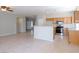 Open-concept floor plan with tile flooring seamlessly connecting the kitchen and living areas at 3591 Driving Range St, Las Vegas, NV 89122