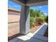 Covered porch provides shade and a glimpse of the home's desert landscape at 3591 Driving Range St, Las Vegas, NV 89122