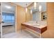 Modern bathroom with double vanity, marble tile, and a view of the bedroom at 4471 Dean Martin Dr # 3908, Las Vegas, NV 89103