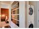 Modern laundry room with stacked washer and dryer and large mirror at 4471 Dean Martin Dr # 3908, Las Vegas, NV 89103