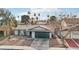 Single-story house with a green garage door and desert landscaping at 6743 Carrera Dr, Las Vegas, NV 89103