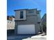 Two-story home featuring a modern design, a two-car garage, neutral paint and a well-maintained landscape at 1558 Rock Kestrel St, Las Vegas, NV 89138