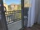 Balcony featuring wrought iron railing and view of neighborhood through sheer white curtains at 177 Almond Ridge Pl, Henderson, NV 89015