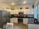 Kitchen with white cabinets, stainless steel appliances, and dark countertops at 177 Almond Ridge Pl, Henderson, NV 89015