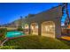 Refreshing pool in a fenced backyard with lush grass and a covered patio at 18 Tarryall Ter, Henderson, NV 89074