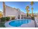 Kidney shaped pool with a spa, surrounded by a patio at 18 Tarryall Ter, Henderson, NV 89074