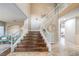 Grand staircase with dark wood treads and white railings at 18 Tarryall Ter, Henderson, NV 89074