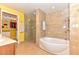 Bathroom with a soaking tub, glass shower, and access to a walk-in closet at 200 W Sahara Ave # 601, Las Vegas, NV 89102
