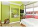 Bedroom featuring large windows, a desk, a bed and vibrant green walls at 200 W Sahara Ave # 601, Las Vegas, NV 89102