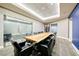 A large conference room with a rustic wooden table, black leather chairs, and modern lighting at 200 W Sahara Ave # 601, Las Vegas, NV 89102