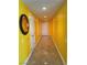 Long hallway with recessed lighting, tile flooring, and bright yellow walls leads to the front door at 200 W Sahara Ave # 601, Las Vegas, NV 89102