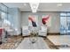 Elegant lobby with gray chairs, marble floors, modern art, and floor-to-ceiling windows overlooking city at 200 W Sahara Ave # 601, Las Vegas, NV 89102