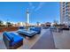 Luxury poolside area with sleek lounge seating, modern fire pit, and Stratosphere view at 200 W Sahara Ave # 601, Las Vegas, NV 89102
