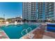 A tranquil swimming pool with clear water reflects the building's facade and the lush landscaping surrounds the relaxing space at 200 W Sahara Ave # 601, Las Vegas, NV 89102