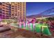 Enjoy a refreshing swim in the turquoise pool, surrounded by manicured landscaping and soft lighting, creating a tranquil escape at 200 W Sahara Ave # 601, Las Vegas, NV 89102