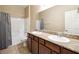 Bathroom with double vanity, tub shower combo, and gray curtains at 2051 Hunt Woods Ct, Laughlin, NV 89029