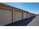 Image of multiple garages with tan doors and red tile roofs under a clear blue sky at 3740 Desert Marina Dr # 7, Laughlin, NV 89029