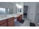Ensuite bathroom featuring double sinks, a vanity area, and separate glass door shower at 4920 Blue Rose St, North Las Vegas, NV 89081
