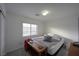 This bedroom has a neutral palette and natural light coming from a window at 4920 Blue Rose St, North Las Vegas, NV 89081