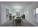 Bright dining room featuring a chandelier, large windows, and space for hosting guests at 4920 Blue Rose St, North Las Vegas, NV 89081