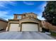 Two-story home showcasing a 3-car garage, shutters, and neutral color palette under a bright blue sky at 4920 Blue Rose St, North Las Vegas, NV 89081