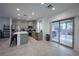 Modern kitchen with stainless steel appliances, an island, and sliding glass doors to backyard at 4920 Blue Rose St, North Las Vegas, NV 89081
