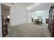 Open-concept living area with neutral tones, carpet flooring and versatile layout with a separate dining area at 4920 Blue Rose St, North Las Vegas, NV 89081