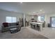 Inviting living room seamlessly connects to a modern kitchen with sleek appliances and center island seating at 4920 Blue Rose St, North Las Vegas, NV 89081