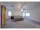 Large main bedroom featuring a ceiling fan and plenty of natural light at 4920 Blue Rose St, North Las Vegas, NV 89081