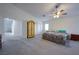 Spacious main bedroom featuring neutral walls, carpet, ceiling fan, and ensuite bathroom at 4920 Blue Rose St, North Las Vegas, NV 89081