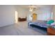 A serene main bedroom features a high ceiling, neutral carpet, and natural light from two windows at 4920 Blue Rose St, North Las Vegas, NV 89081