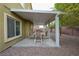 Charming covered patio for outdoor dining and relaxation with shaded seating at 4920 Blue Rose St, North Las Vegas, NV 89081