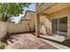 Cozy backyard with a brick patio and sliding glass doors to the home at 4977 Crimson Mare Rd, Las Vegas, NV 89139