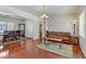 Open-concept living room with hardwood floors connecting the dining and living areas at 4977 Crimson Mare Rd, Las Vegas, NV 89139