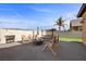 Inviting backyard featuring a cozy fire pit, swing seating, and well-maintained patio space at 5944 Vizzi Ct, Las Vegas, NV 89131
