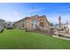 Spacious backyard with artificial grass, patio, and relaxing lounge area at 5944 Vizzi Ct, Las Vegas, NV 89131