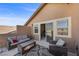 Outdoor balcony featuring cozy seating, a covered area, and sliding doors for indoor-outdoor living at 5944 Vizzi Ct, Las Vegas, NV 89131