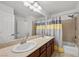 Bright bathroom featuring double sinks, granite countertops, and modern fixtures at 5944 Vizzi Ct, Las Vegas, NV 89131