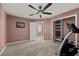 Cozy bedroom with a ceiling fan, closet, and doorway to other rooms at 5944 Vizzi Ct, Las Vegas, NV 89131