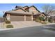 Lovely home with desert landscaping, a three-car garage, and tile roof provides desert living at its finest at 5944 Vizzi Ct, Las Vegas, NV 89131