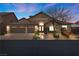 Beautiful home exterior with a three-car garage and well-manicured landscaping at 5944 Vizzi Ct, Las Vegas, NV 89131