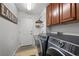 Modern laundry room with front loading washer and dryer, storage cabinets and utility sink at 5944 Vizzi Ct, Las Vegas, NV 89131