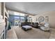 Bright living room featuring a ceiling fan, lots of natural light, and neutral-toned decor at 5944 Vizzi Ct, Las Vegas, NV 89131