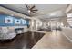Open-concept living room with wood and tile floors and blue accent wall at 5944 Vizzi Ct, Las Vegas, NV 89131