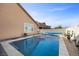 Backyard pool with attached spa, desert landscaping, and privacy wall for serene outdoor living at 5944 Vizzi Ct, Las Vegas, NV 89131