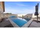 Refreshing backyard pool with a spa, surrounded by stylish decking and desert landscaping at 5944 Vizzi Ct, Las Vegas, NV 89131