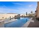 Backyard oasis with a sparkling pool, stylish lounging area, and desert-inspired landscaping at 5944 Vizzi Ct, Las Vegas, NV 89131