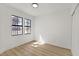 Bright bedroom with two windows, light walls, and wood-look flooring at 6776 Arroyo Ave, Las Vegas, NV 89103