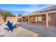 Large backyard with covered patio, fire pit, and gravel landscaping at 7921 Cadenza Ln, Las Vegas, NV 89123